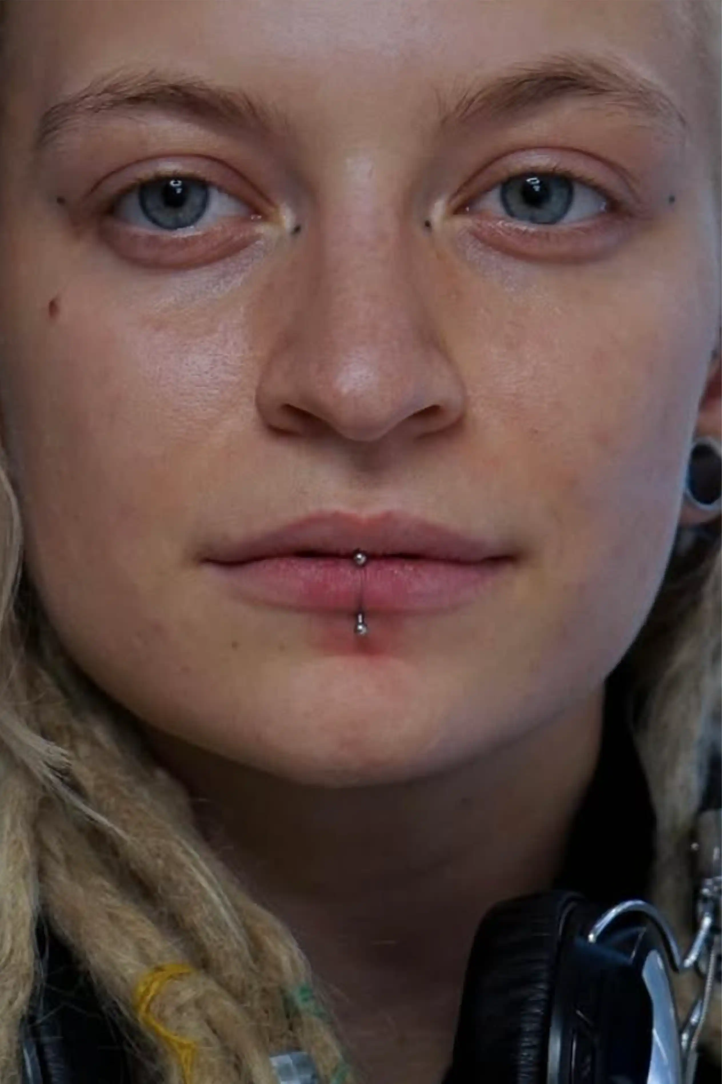 Vertical Labret szájpiercing: az alsó ajak közepén áthaladó ívelt titán ékszer, Soospierce Budapest.